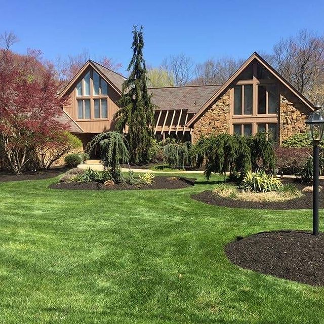 Brown stone house, grass and trees