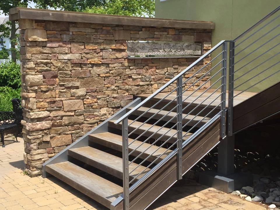 stone block wall and stairs with metal railing