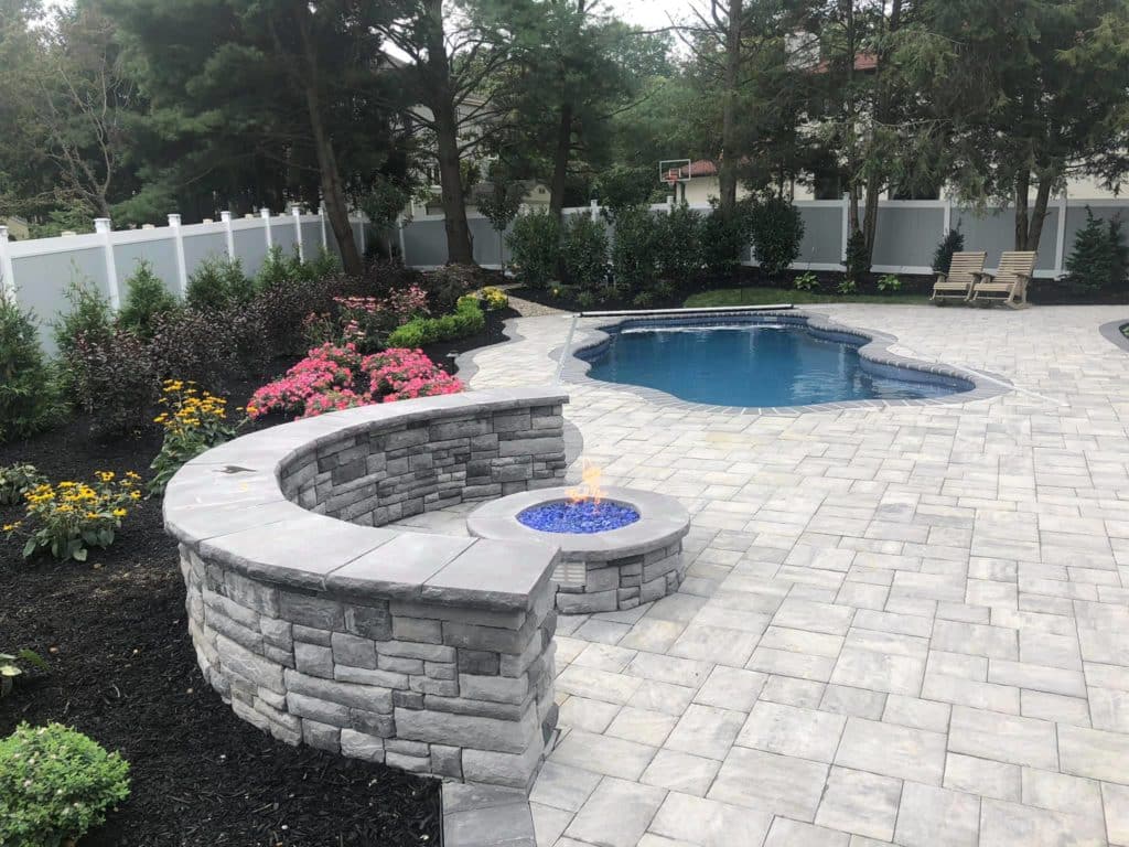 Stonework bench, fireplace, and pool