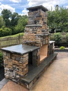 outdoor stone block fireplace with counters