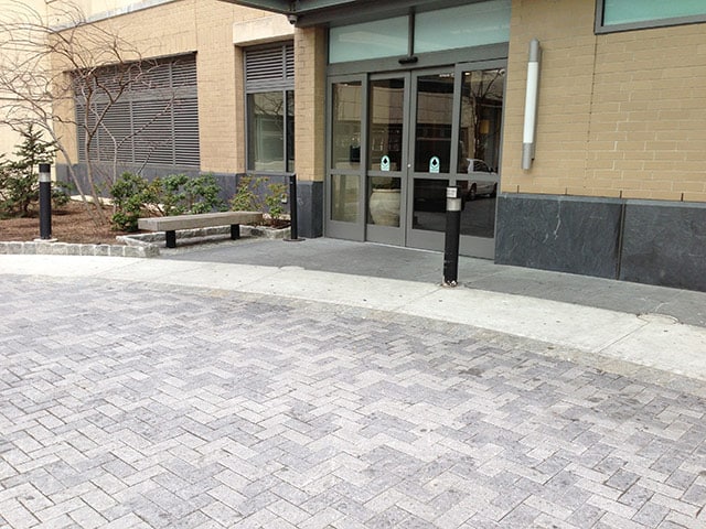 grey pattern brick driveway and glass doors